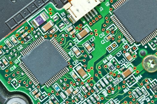 The modern printed-circuit board with electronic components macro background