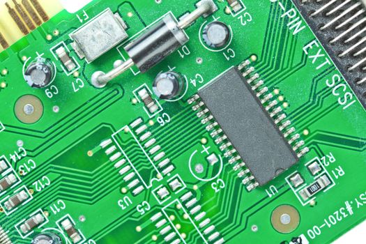 The modern printed-circuit board with electronic components macro background