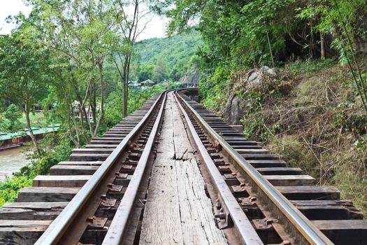 curve train rails with a forest at the background