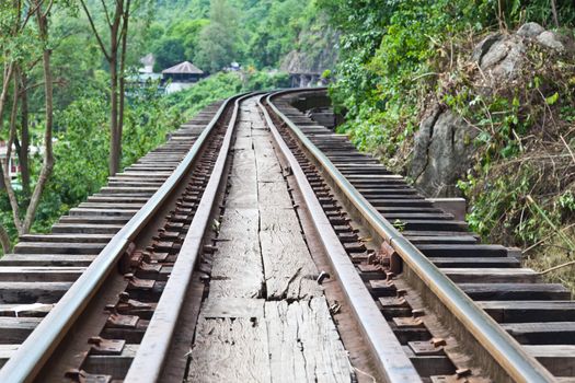 curve train rails with a forest at the background