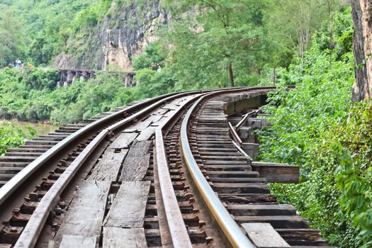 curve train rails with a forest at the background