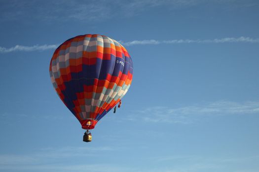Hot air balloon on blue background with red blue and white highlights.