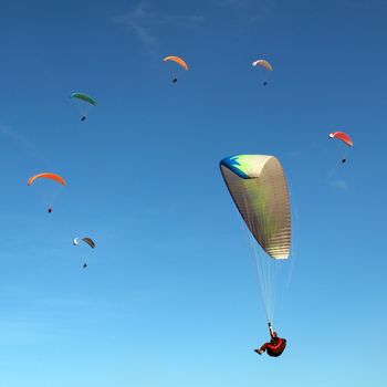 The ring of the paragliders flying in the sky 