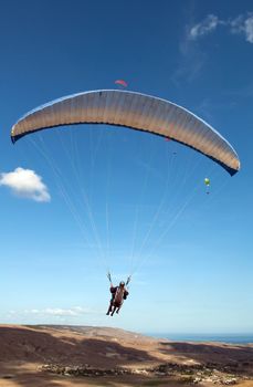 Paraglider flying in the sky