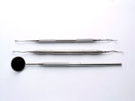 Aranged Dental Instruments on white background, metal, iron, steel, mirror