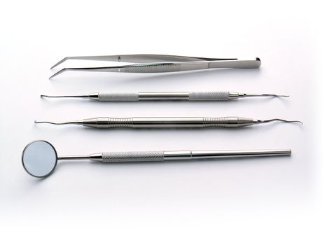 Aranged Dental Instruments on white background, metal, iron, steel, mirror