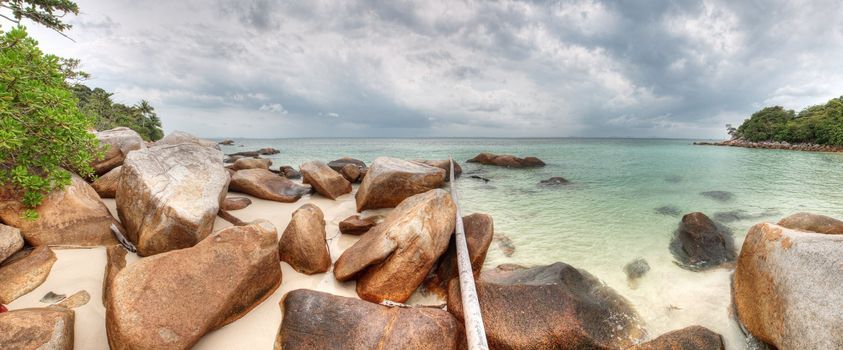 Panoramic view of a beach with large stones in Pulau Besar in Malaysia