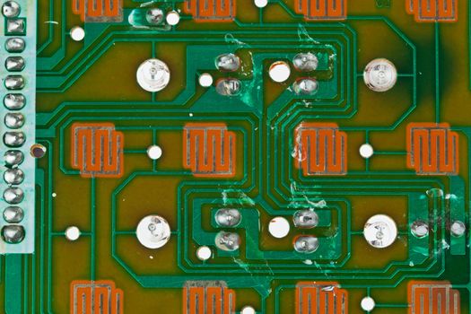 The modern printed-circuit board with electronic components macro background