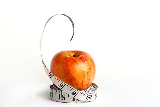Tape measure and an apple characterise diet possibility.