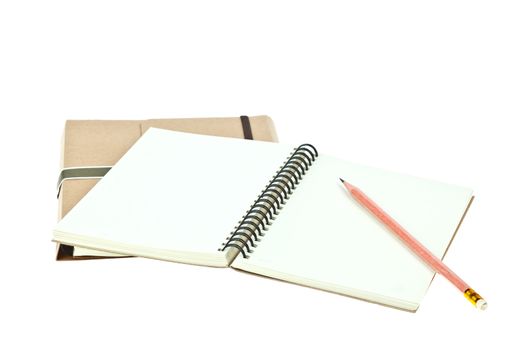 Isolated Light cream color paper note book on brown book and pencil