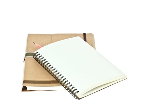 Isolated Light cream color paper note book on brown book