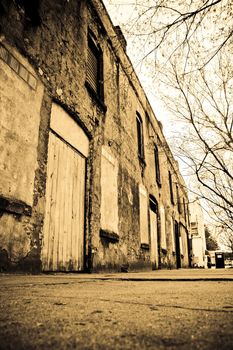 A grungy, abandoned brick building on the outskirts of town.