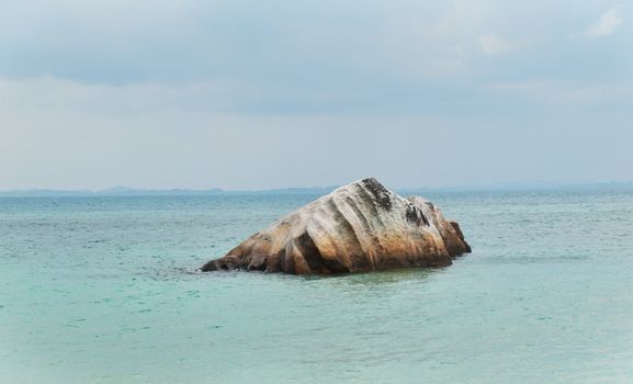 Big rock offshore from a small island in Malaysia