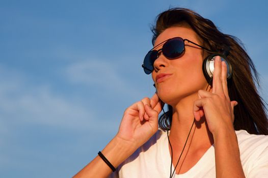 A cool young man listens to music on some headphones