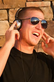 A cool young man listens to music on some headphones