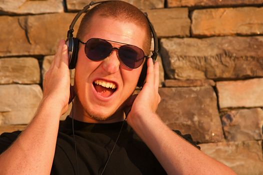 A cool young man listens to music on some headphones