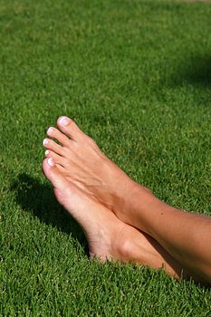 Relaxed feet of a woman laying in the grass