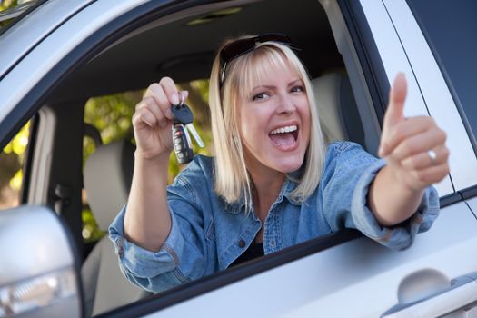 Attractive Happy Woman In New Car with Keys.