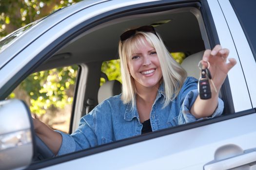 Attractive Happy Woman In New Car with Keys.