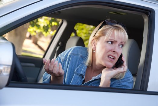 Concerned Blonde Woman Using Cell Phone While Driving.