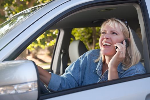 Attractive Blonde Woman Using Cell Phone While Driving