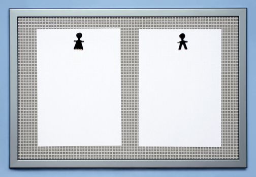 Magnetic memo board with blank sheets held by magnets which symbolise a woman and a man. Insert your own thoughts about the differences between the sexes.
