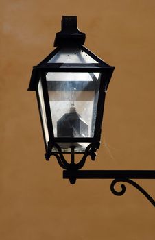 streetlamp with spidernet and reflections in gamla stan Stockholm