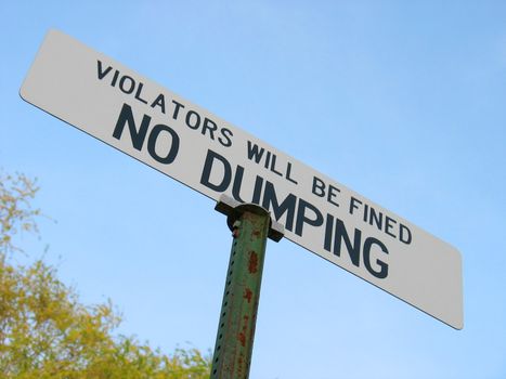 A sign that reads "NO DUMPING - VIOLATORS WILL BE FINED".  Great for the "going green" environmental movement.