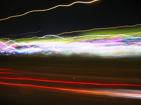 Abstract light trails captured from cars, signs, and other landmarks.