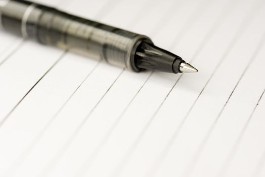 A pen on a blank paper ready to write