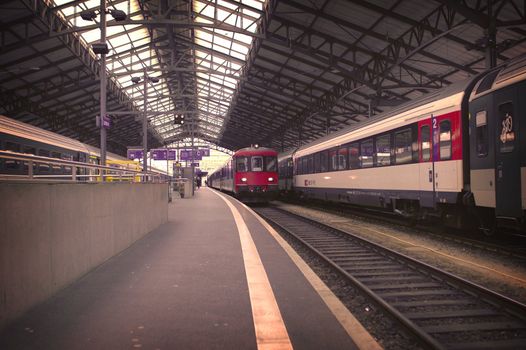 Image form the train station in Lausanne Switzerland showing Incoming and outgoing trains.