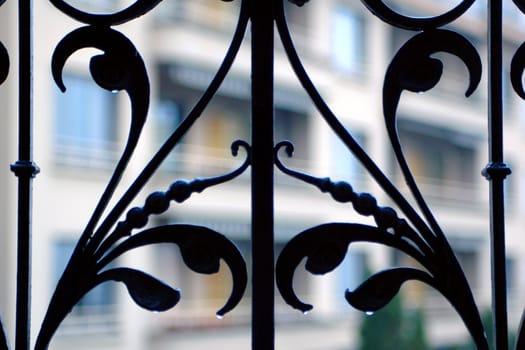 Close up image of iron work on Hotel balcony railing in the rain.