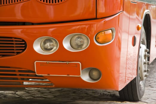 Detail shot of a red us, with empty license plate. Perpendicular shot.