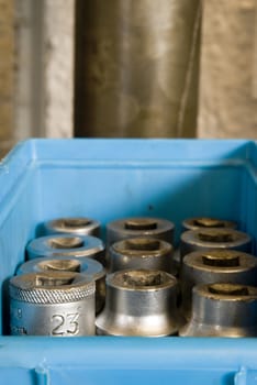 Details shot of a box full of screw driver sockets.