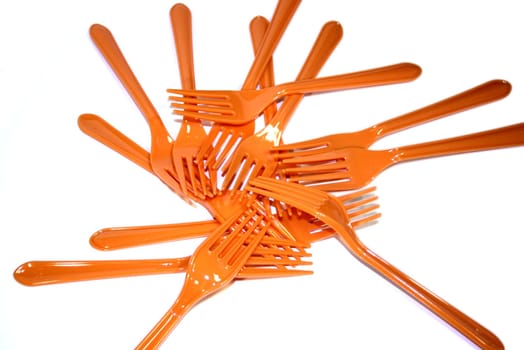 Orange plastic forks on White background