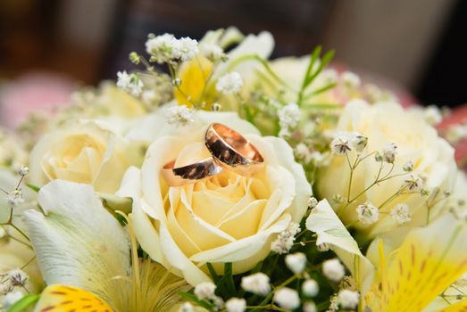 Wedding rings on a bridal bouquet