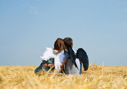 Young happy couple on the field. Shoot on the nature.