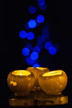 Burning candle on a blurred color background