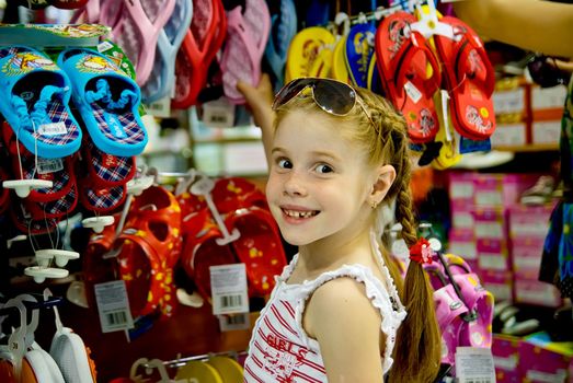 A little girl in a shoe store