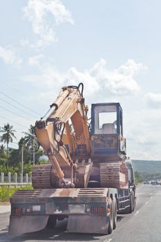 Tractor Excavator on truck, moving