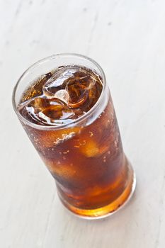 Water, Fresh coke in glass, on white wood