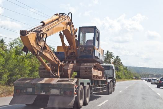 Tractor Excavator on truck, moving