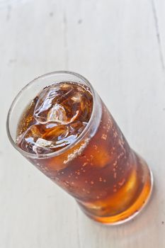 Water, Fresh coke in glass, on white wood