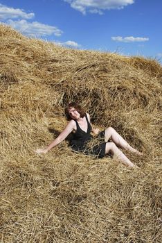 the young woman is relax on the hay