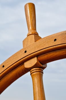 Wooden steering wheel against the blue sky