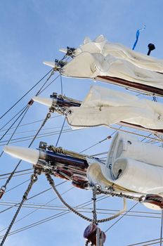 Vintage rigging of sailboat. Mast with white sails