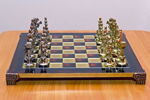 glossy chess board with cast metal game pieces