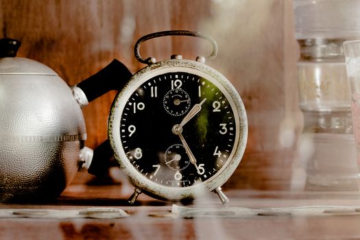 Vintage old alarm clock in glass closet as sepia tone