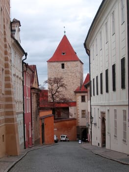  Streets of Prague. Tower with a red roof on a background. A city landscape.