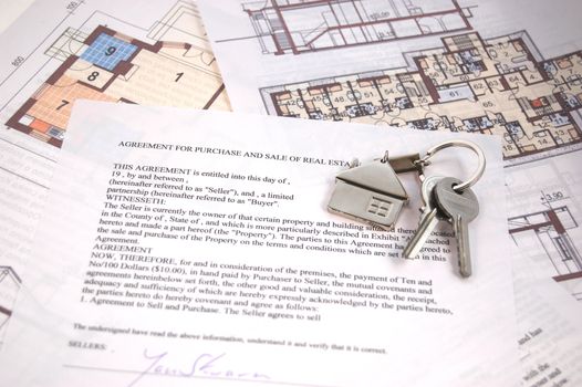 Keys on mortgage note and blueprints